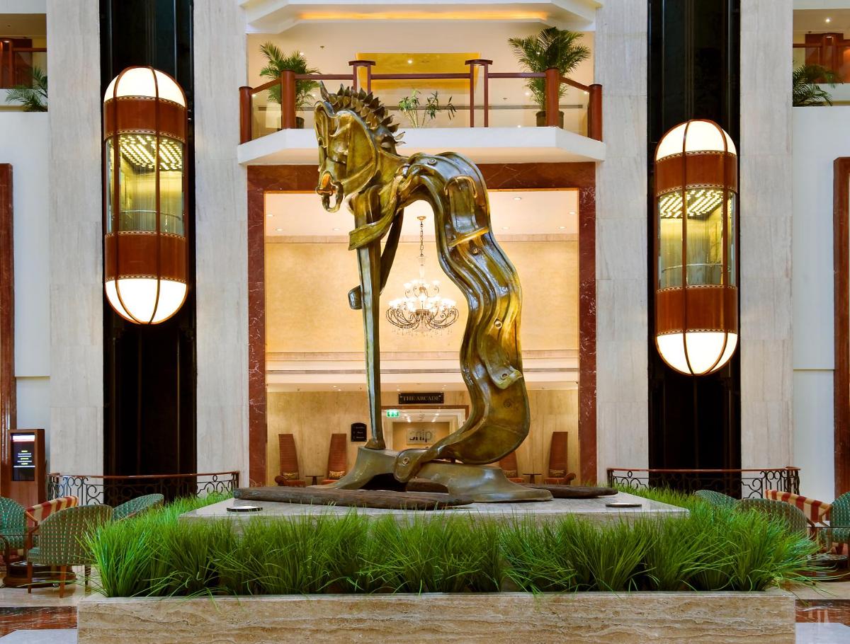 a bronze horse statue in front of a building at The Lalit Mumbai in Mumbai