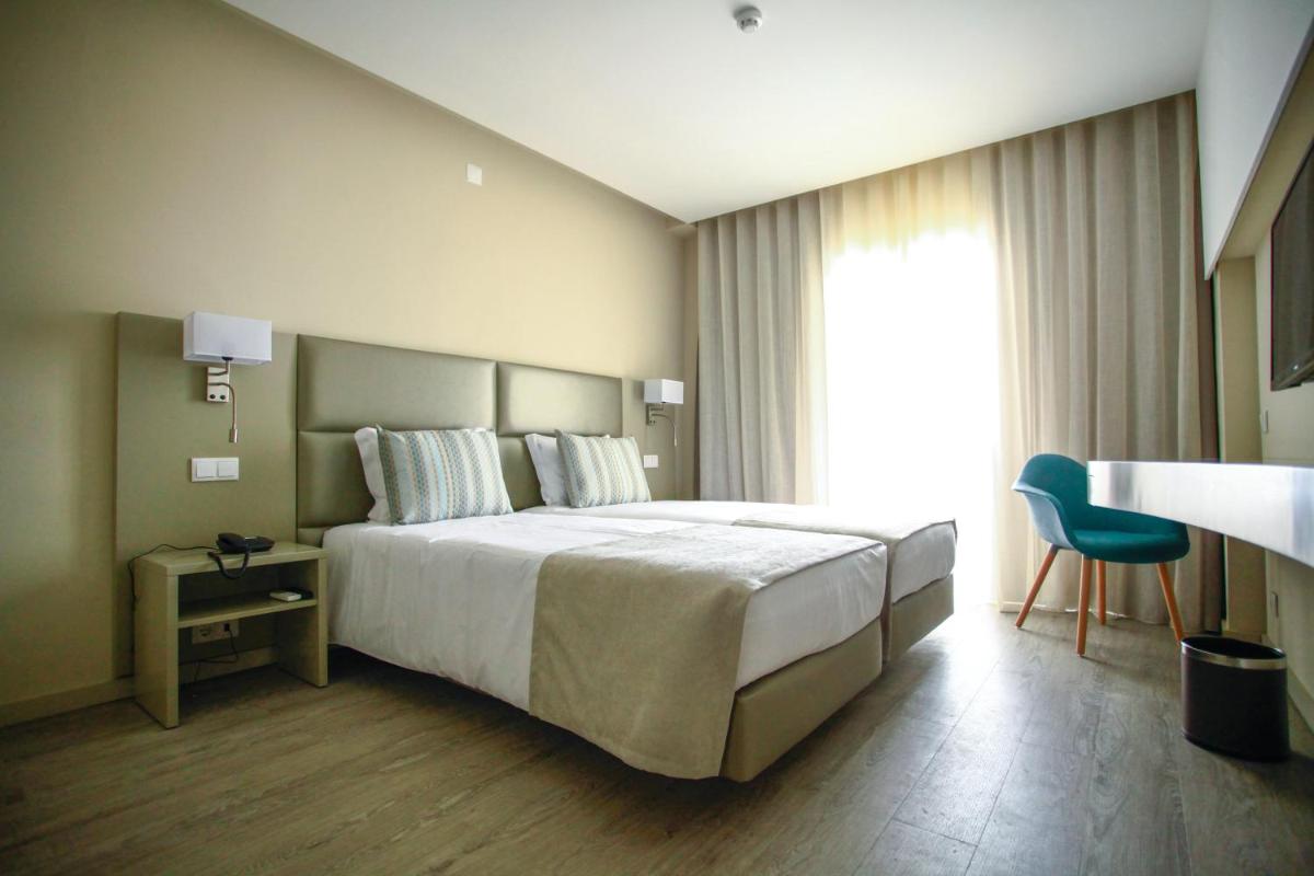 Uma cama ou camas num quarto em AP Maria Nova Lounge - Adults Friendly