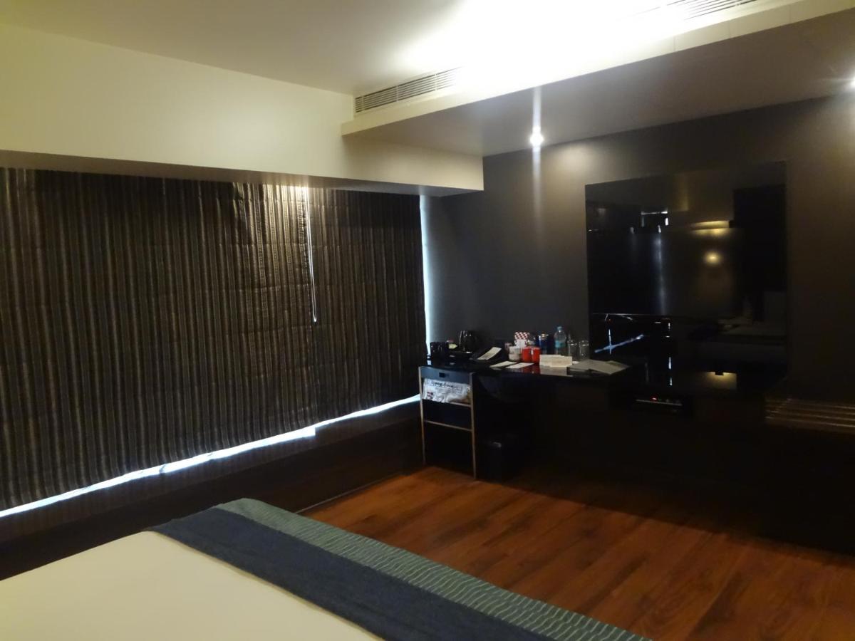 a bathroom with black walls and a sink and a counter at Svenska Design Hotel in Mumbai