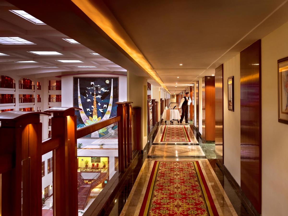 a hallway with rugs on the floors of a building at The Lalit Mumbai in Mumbai
