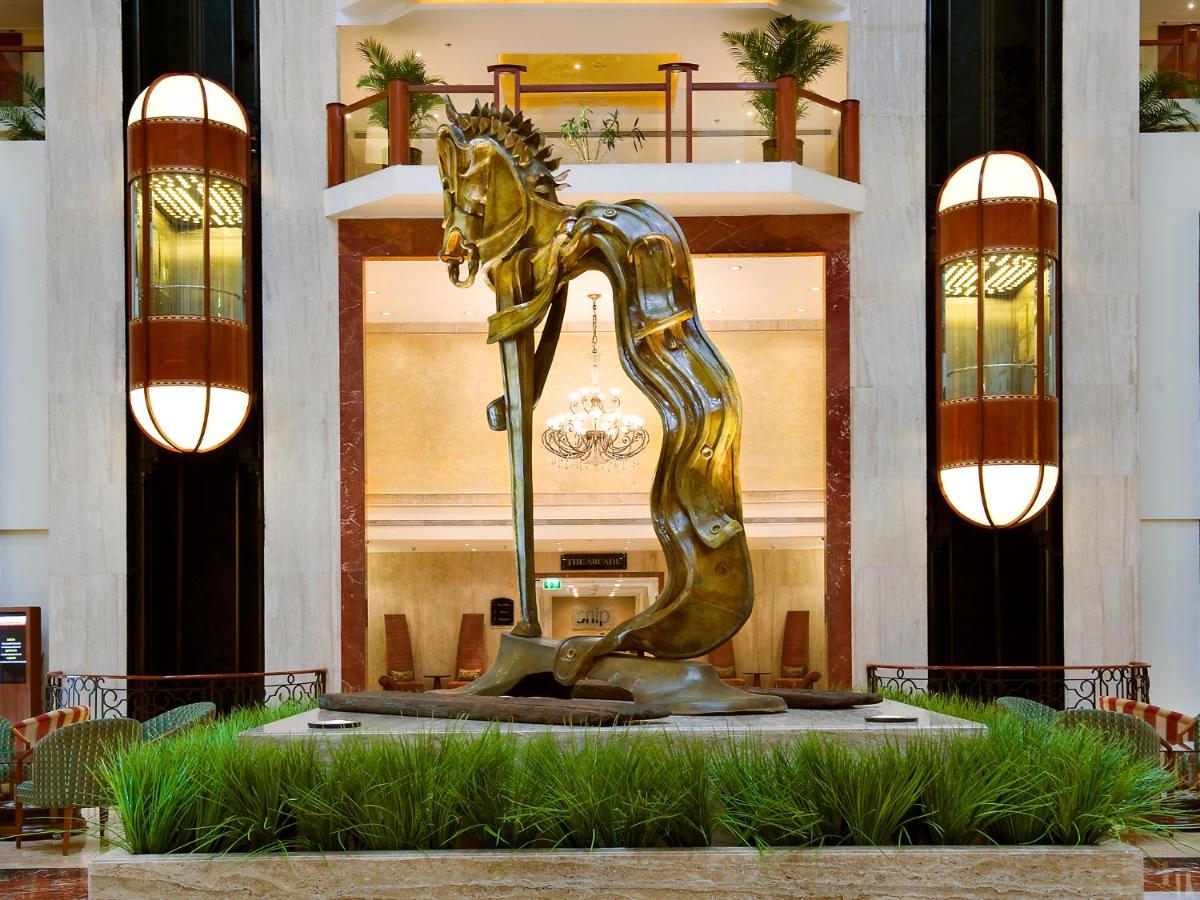 a bronze horse statue in front of a building at The Lalit Mumbai in Mumbai