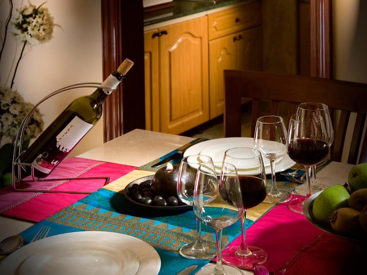 a table with wine glasses and a bottle of wine at The Lalit Mumbai in Mumbai