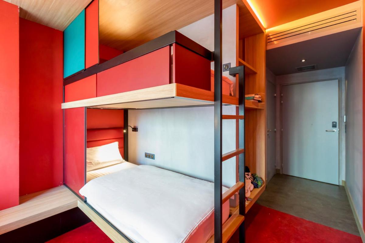 Un ou plusieurs lits dans un hébergement de l'établissement YOOMA Urban Lodge Tour Eiffel