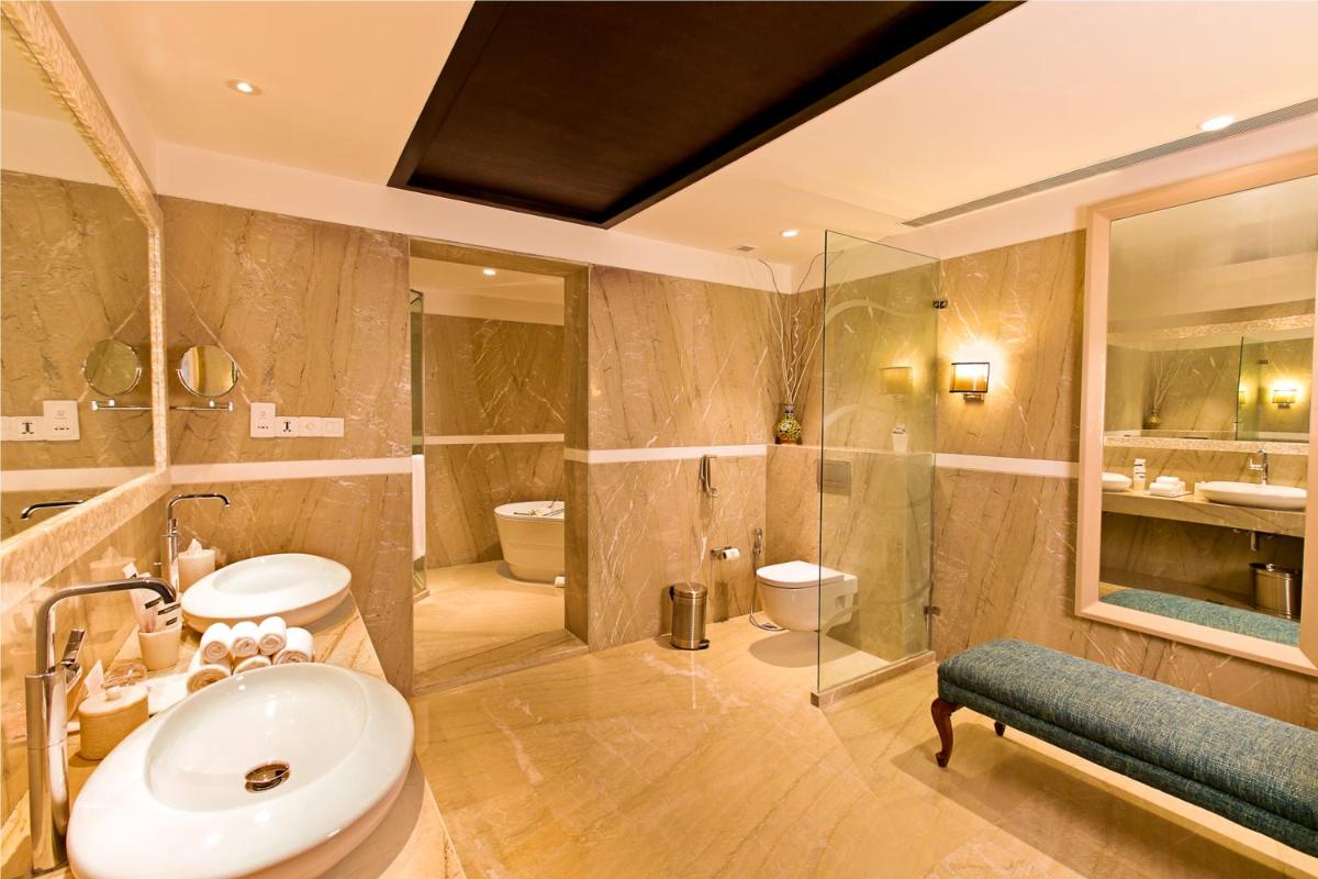 a large bathroom with a sink and a shower at The Lalit Jaipur in Jaipur a large bathroom with a sink and a shower at The Lalit Jaipur in Jaipur