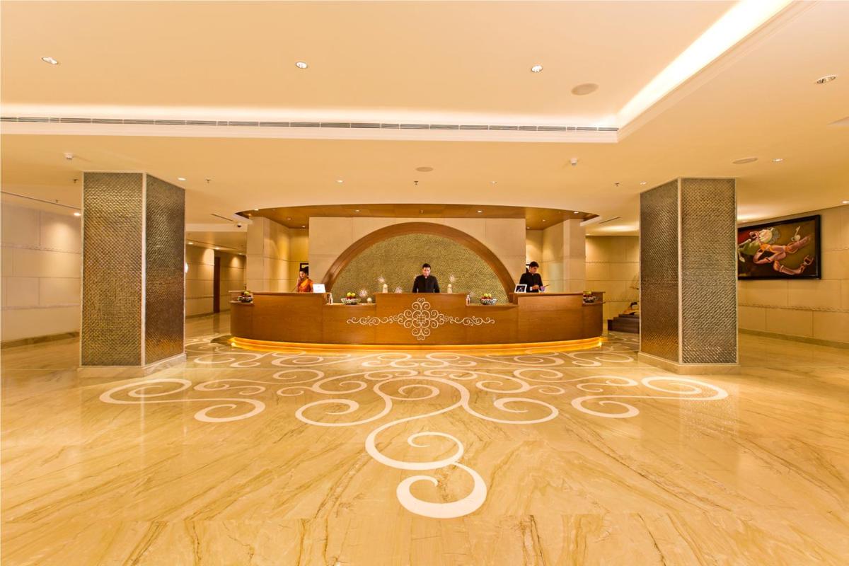 a lobby of a hotel with a reception desk at The Lalit Jaipur in Jaipur