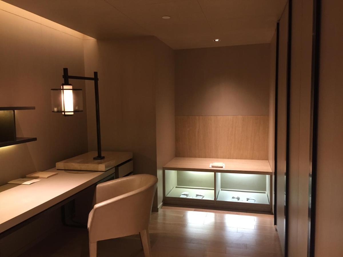 a room with a desk with a chair and a lamp at Roseate House New Delhi in New Delhi a room with a desk with a chair and a lamp at Roseate House New Delhi in New Delhi