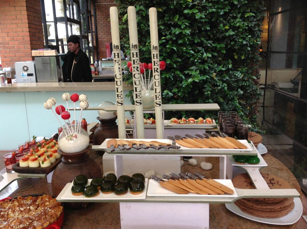 a buffet of desserts and pastries on a table at Hotel Royal Orchid Bangalore in Bengaluru