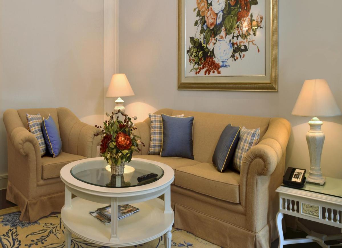 a living room with two couches and a table at Welcomhotel by ITC Hotels, The Savoy, Mussoorie in Mussoorie