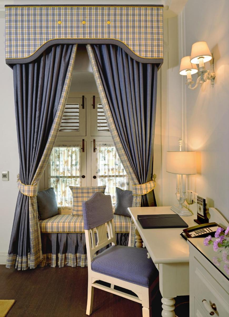 a desk and chair in a room with a window at Welcomhotel by ITC Hotels, The Savoy, Mussoorie in Mussoorie