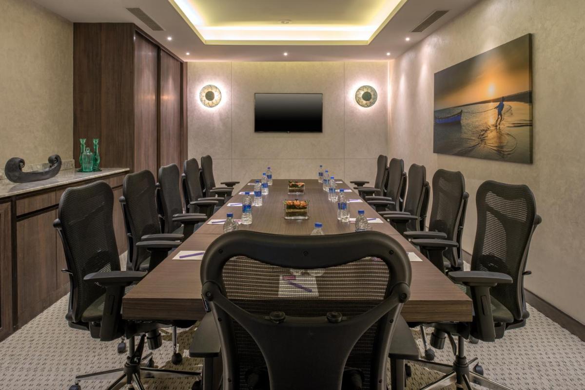 a conference room with a long table and chairs at The Residency Towers, Rameswaram in Rāmeswaram +48 photos