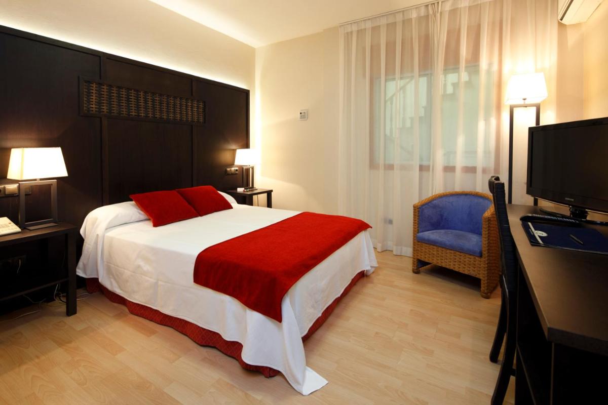 Cama o camas de una habitación en Hotel Spa Congreso
