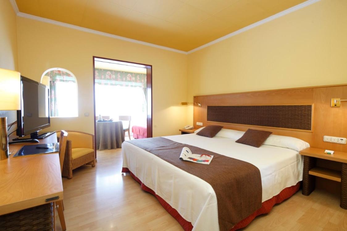 Cama o camas de una habitación en Hotel Spa Congreso