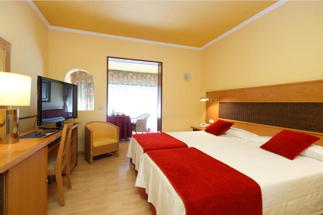 Cama o camas de una habitación en Hotel Spa Congreso