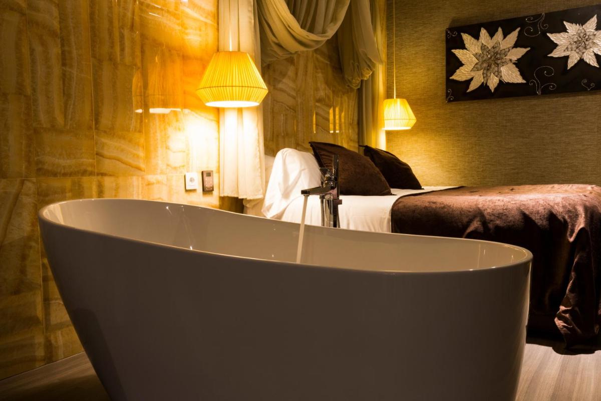 Cama o camas de una habitación en Sant Jordi Boutique Hotel