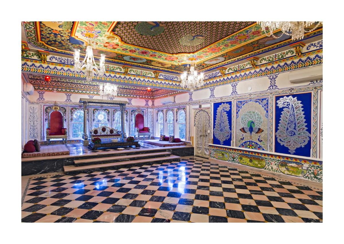 a room with a checkerboard floor and a ceiling at Chunda Palace in Udaipur