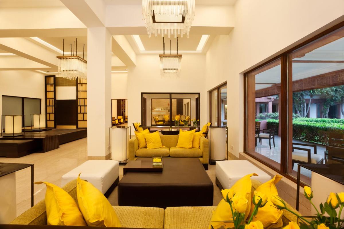a living room with yellow pillows and a couch at Trident Agra in Agra