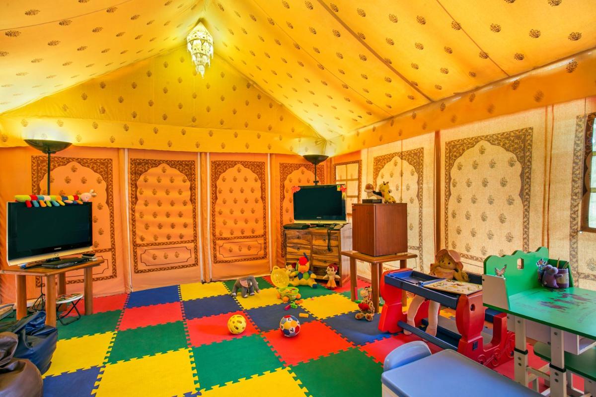 a living room filled with toys and a tv at Trident Agra in Agra