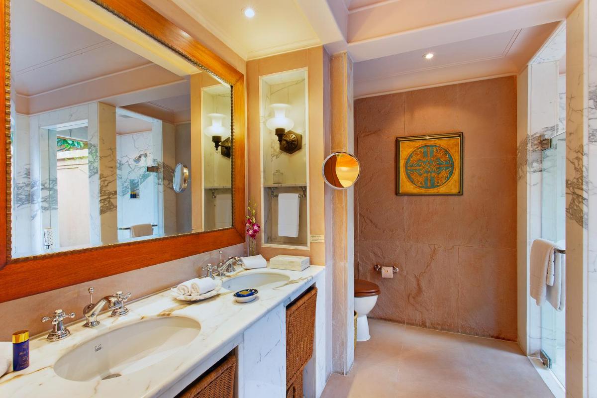 a bathroom with two sinks and a large mirror at The Oberoi Rajvilas Jaipur in Jaipur