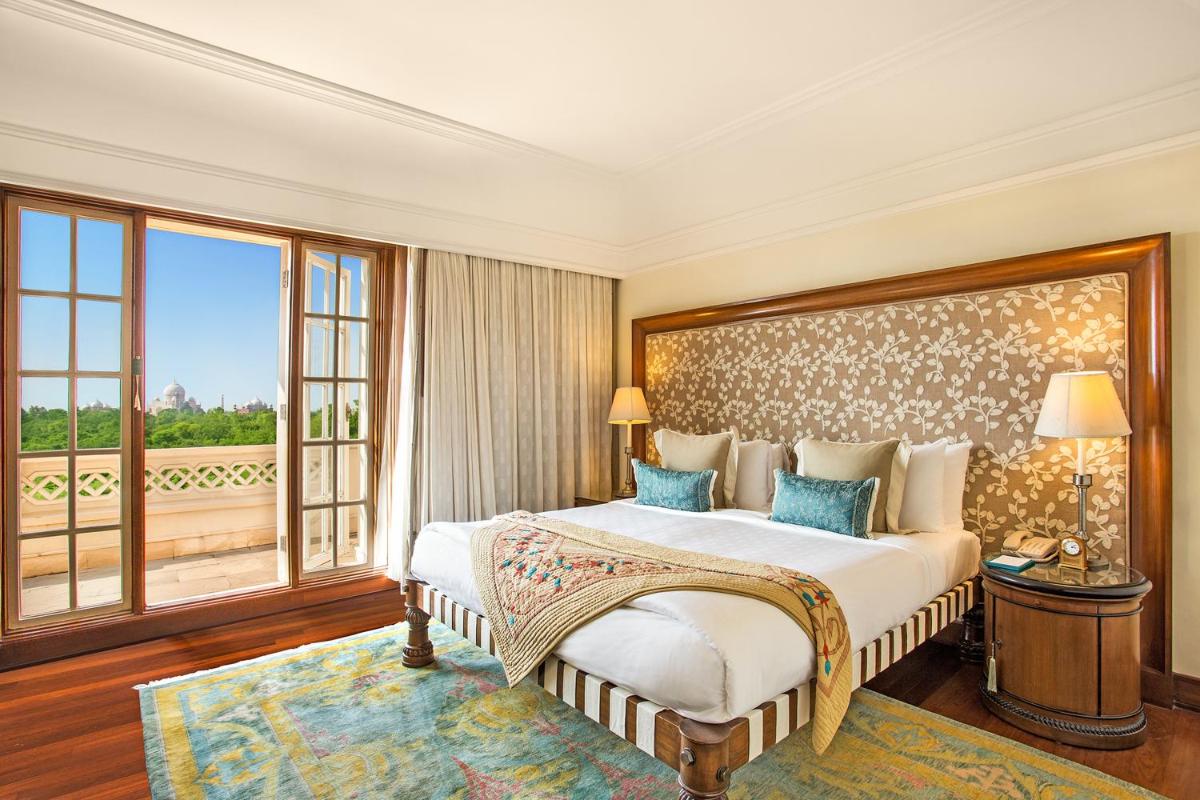 a bedroom with a large bed and a large window at The Oberoi Amarvilas Agra in Agra
