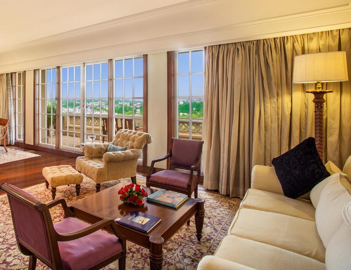 a living room with a couch and chairs and a table at The Oberoi Amarvilas Agra in Agra