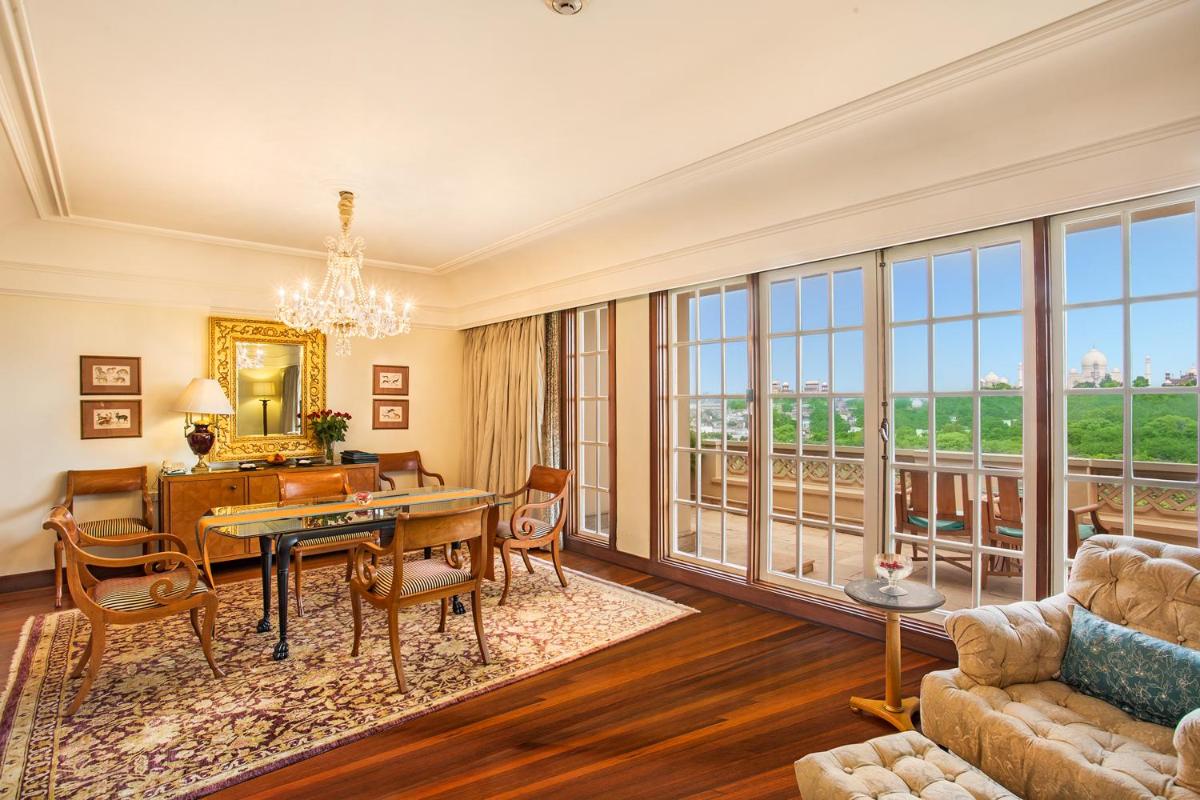 a living room with a table and chairs at The Oberoi Amarvilas Agra in Agra