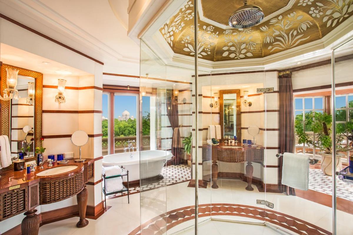 a bathroom with a tub and a sink and a shower at The Oberoi Amarvilas Agra in Agra