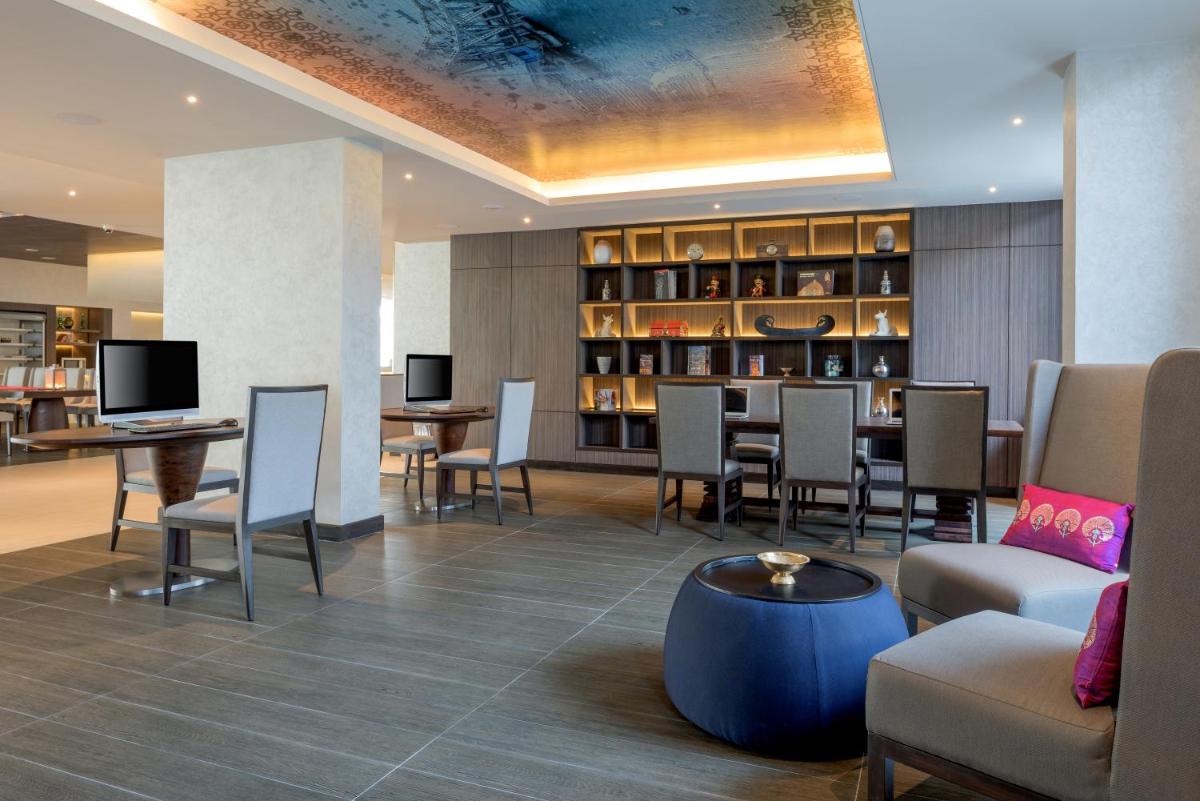 a restaurant with chairs and a table and a bar at The Residency Towers, Rameswaram in Rāmeswaram