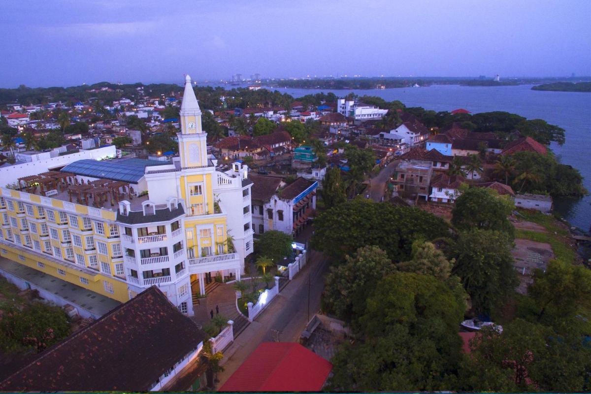 a large white building with a tower on top of it at Fragrant Nature Kochi - A Five star Classified Hotel in Cochin