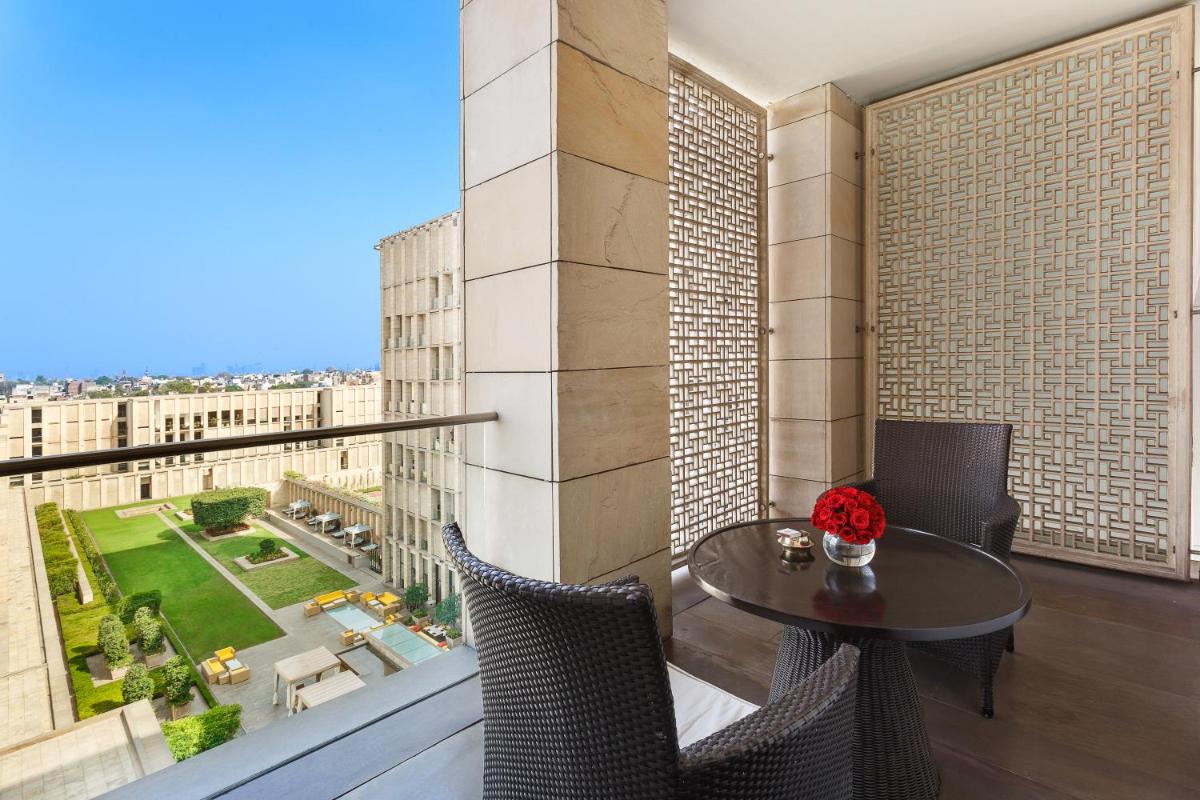 a balcony with a table and a view of a city at The Lodhi – A member of The Leading Hotels Of The World in New Delhi