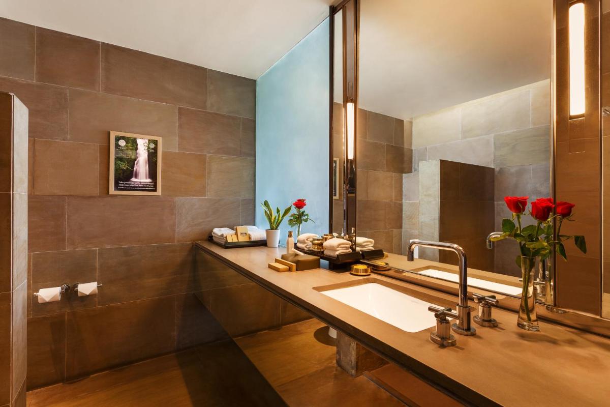 a bathroom with a sink and a mirror at The Lodhi – A member of The Leading Hotels Of The World in New Delhi