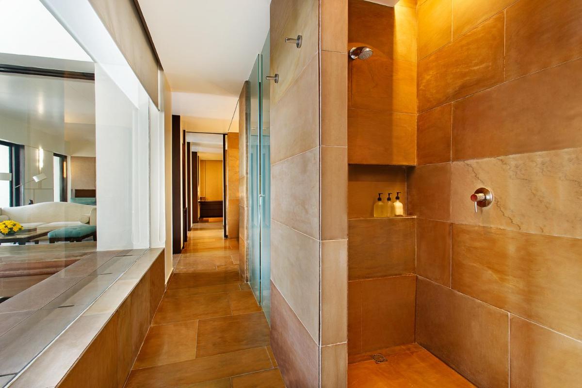 a hallway of a home with a walk in shower at The Lodhi – A member of The Leading Hotels Of The World in New Delhi