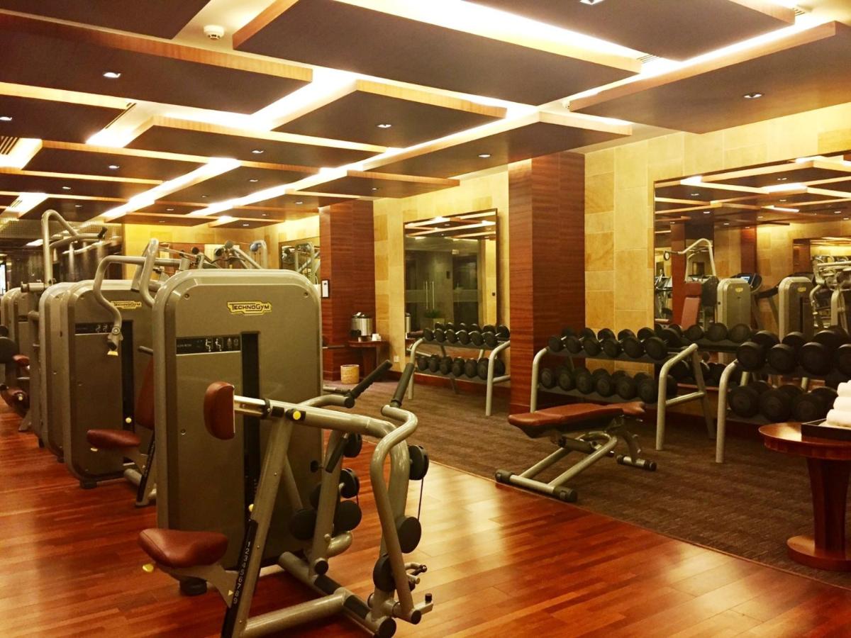 a gym with a bunch of chairs and machines at Jaypee Palace Hotel in Agra