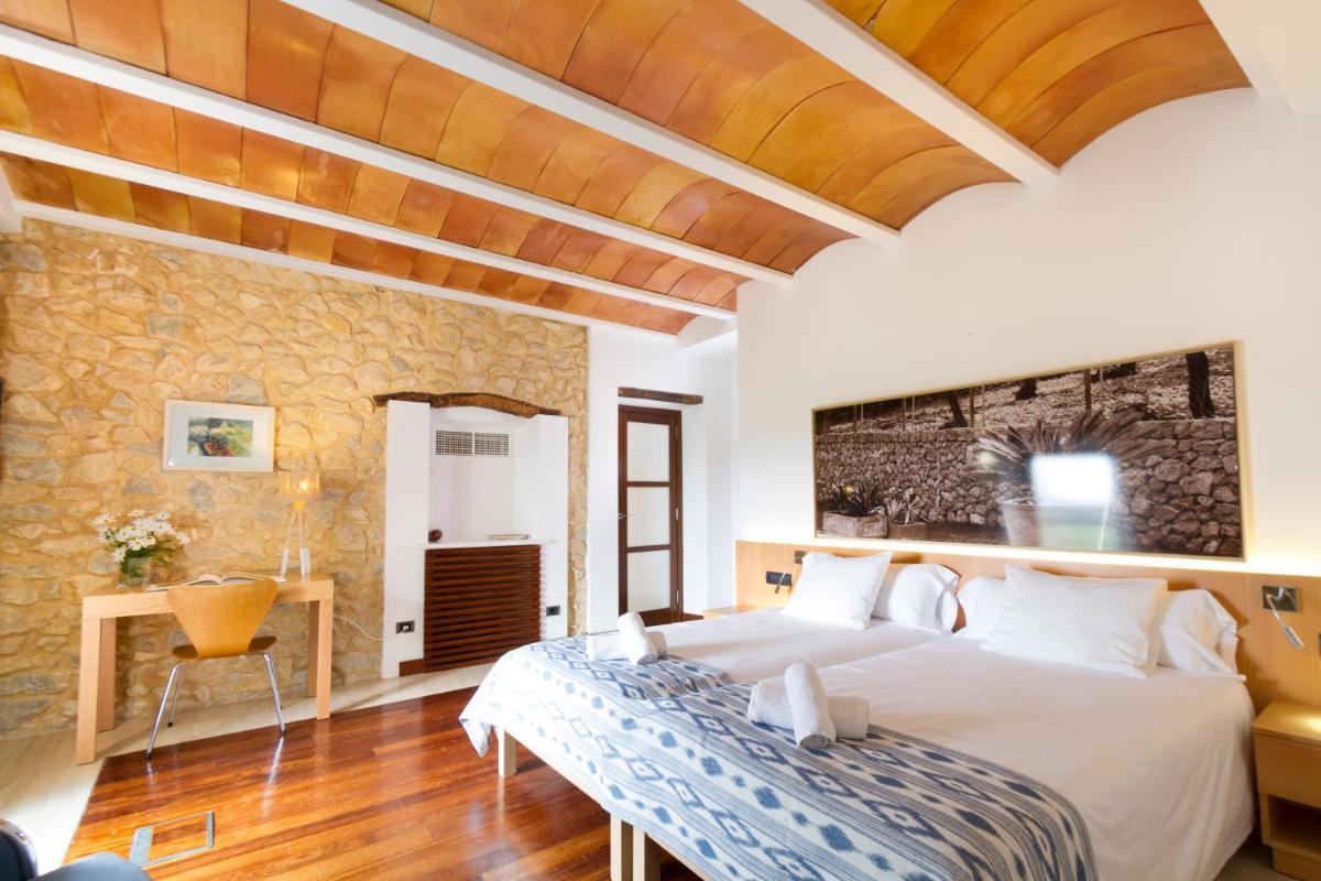 Cama o camas de una habitación en Can Cota Boutique - Turismo de interior
