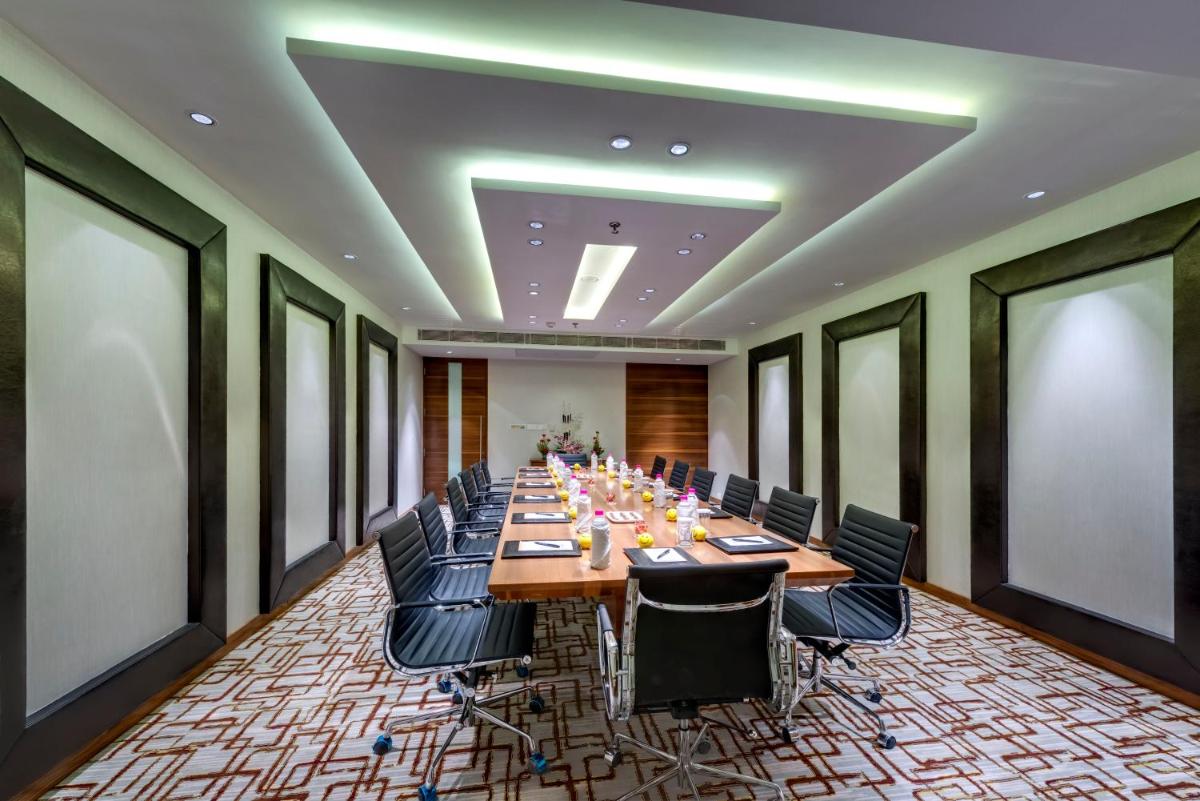 a large conference room with a long table and chairs at Pride Plaza Hotel, Kolkata in Kolkata