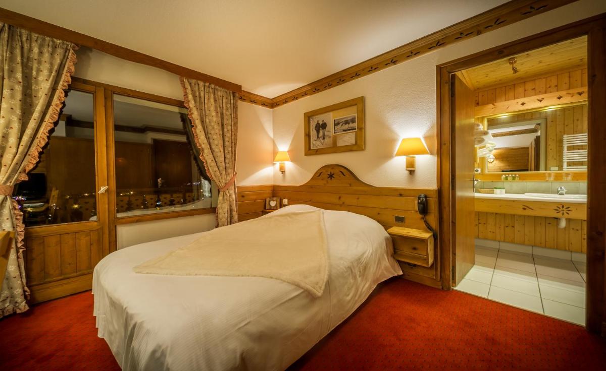 Un ou plusieurs lits dans un hébergement de l'établissement Hotel & Spa Le Dahu