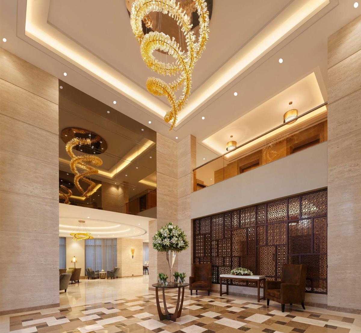 a lobby with a chandelier in a hotel at Novotel Lucknow Gomti Nagar in Lucknow +57 photos