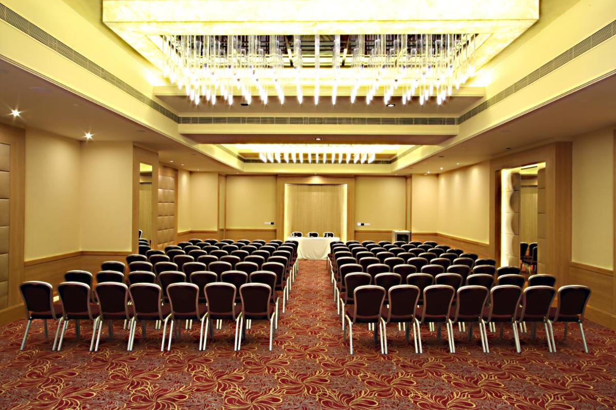 a conference room with chairs and a chandelier at Radisson Hyderabad Hitec City in Hyderabad
