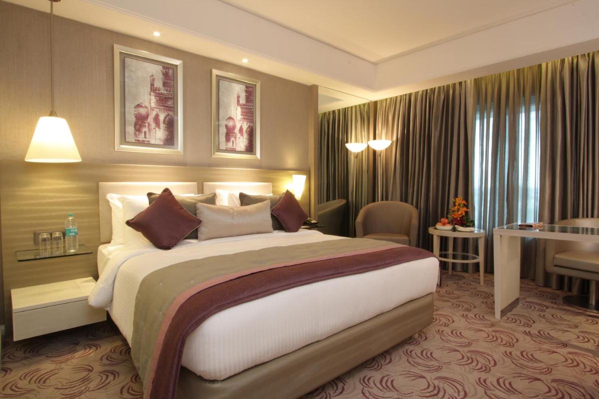 a bedroom with a large bed in a hotel room at Radisson Hyderabad Hitec City in Hyderabad