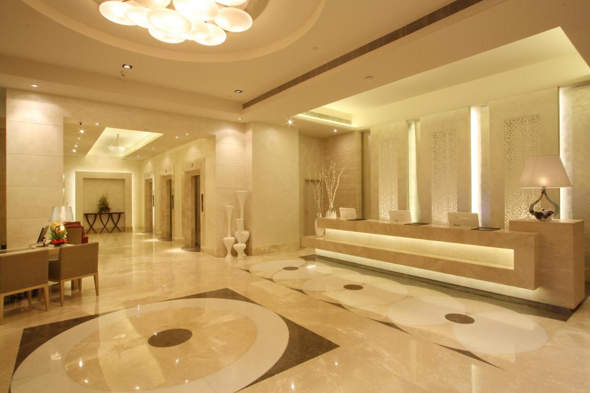 a lobby with a large room with a table at Radisson Hyderabad Hitec City in Hyderabad