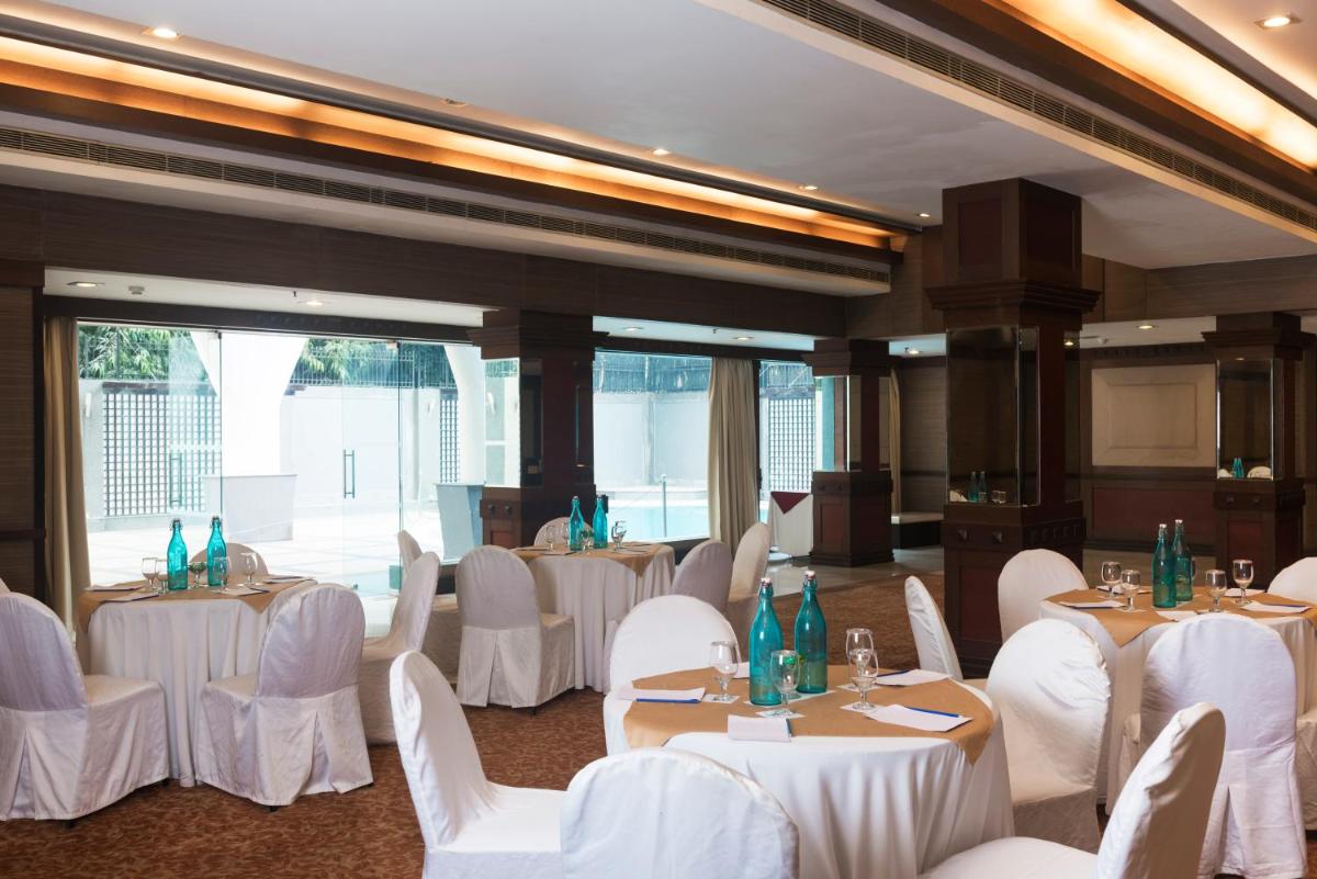 a banquet hall with white tables and white chairs at Park Inn by Radisson,South Delhi in New Delhi a banquet hall with white tables and white chairs at Park Inn by Radisson,South Delhi in New Delhi