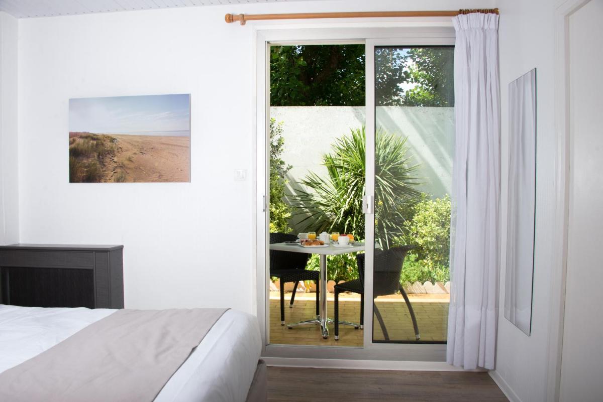 Un ou plusieurs lits dans un hébergement de l'établissement Hotel Les Dunes