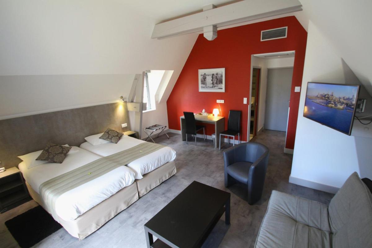 Un ou plusieurs lits dans un hébergement de l'établissement Logis Hotel Archambeau