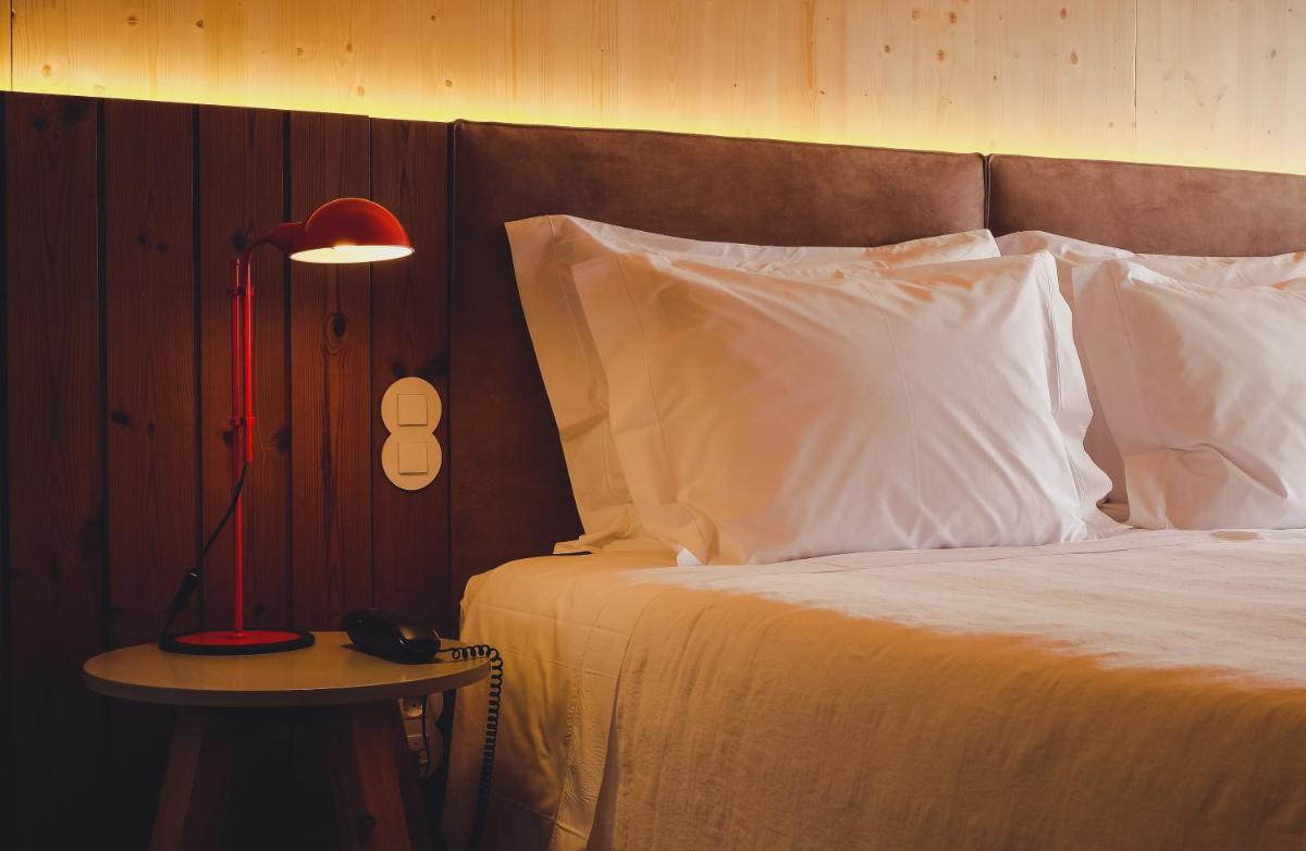 Uma cama ou camas num quarto em FeelViana Sport Hotel