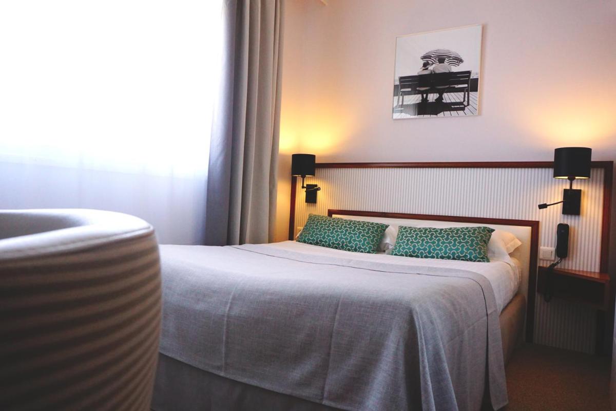 Un ou plusieurs lits dans un hébergement de l'établissement Atlantic Hôtel & Spa