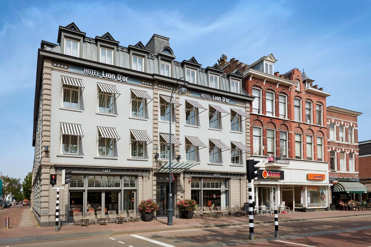 a large white building on the corner of a street at Hotel Lion D'Or in Haarlem