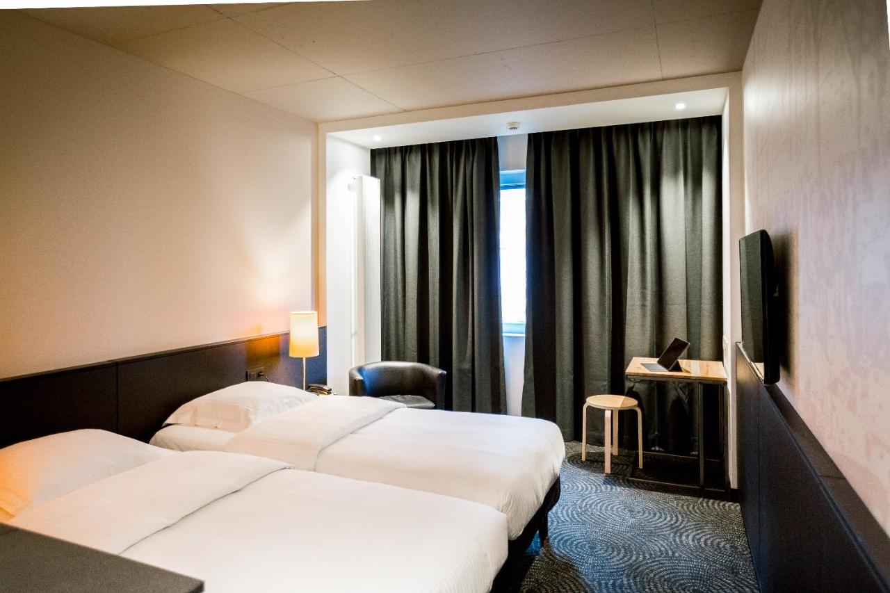 Een bed of bedden in een kamer bij Hotel Van Belle