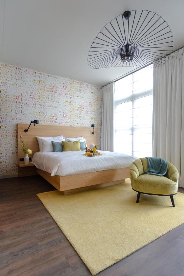 Een bed of bedden in een kamer bij Boutique Hotel Catshuis