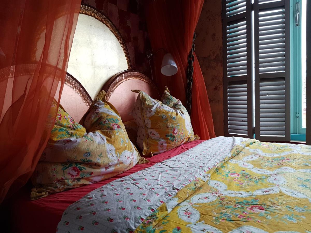 a bedroom with a bed with pillows and a window at Drijfpaleis in Arnhem