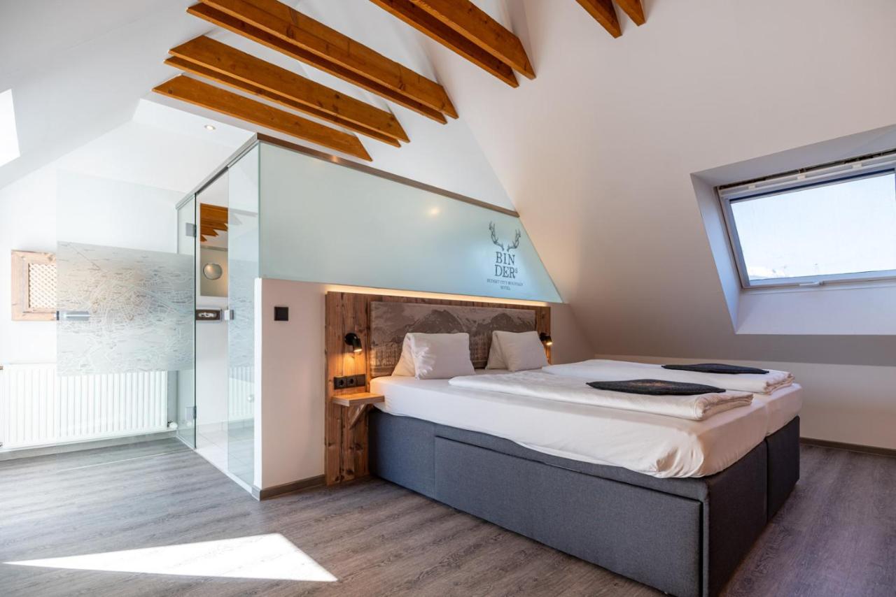 a bedroom with a large bed and a window at BinderS Budget City-Mountain Hotel in Innsbruck
