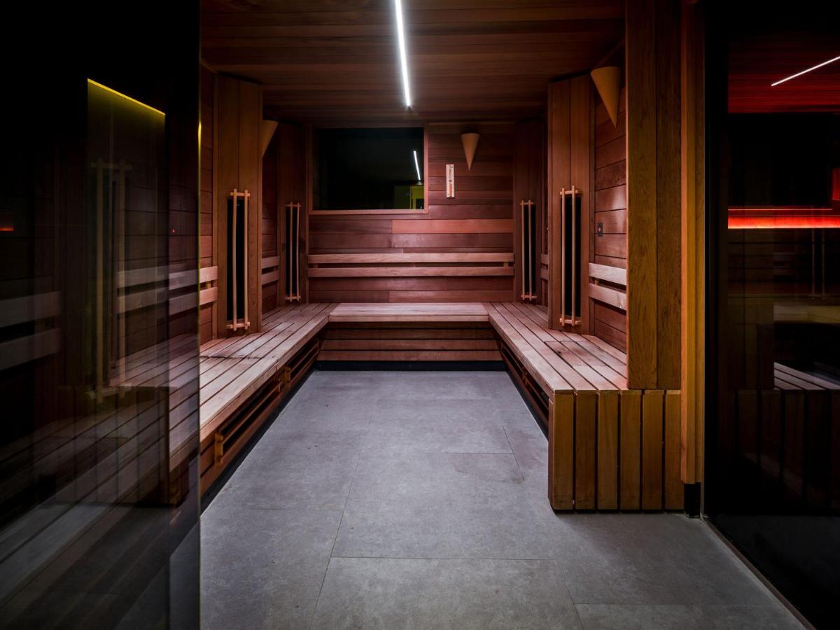 an empty room with wooden benches in a building at Hotel Van der Valk Maastricht in Maastricht